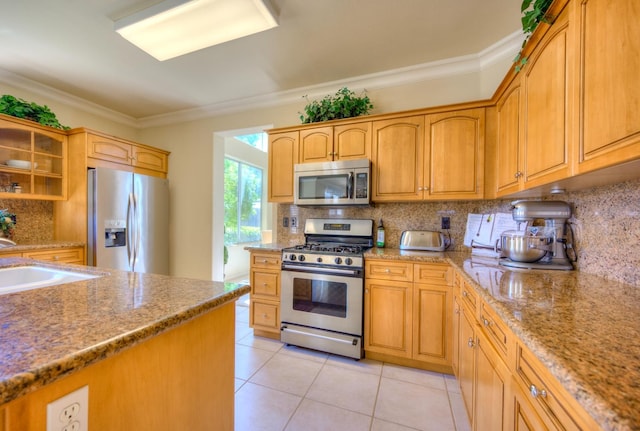 kitchen with light tile patterned floors, stainless steel appliances, decorative backsplash, ornamental molding, and a sink