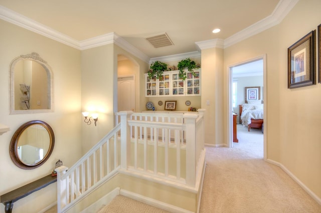 hall with baseboards, visible vents, crown molding, carpet flooring, and recessed lighting