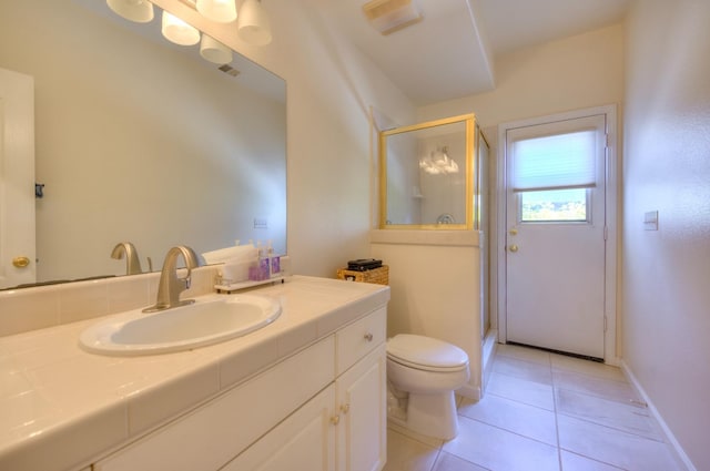 bathroom featuring a stall shower, vanity, toilet, and tile patterned floors