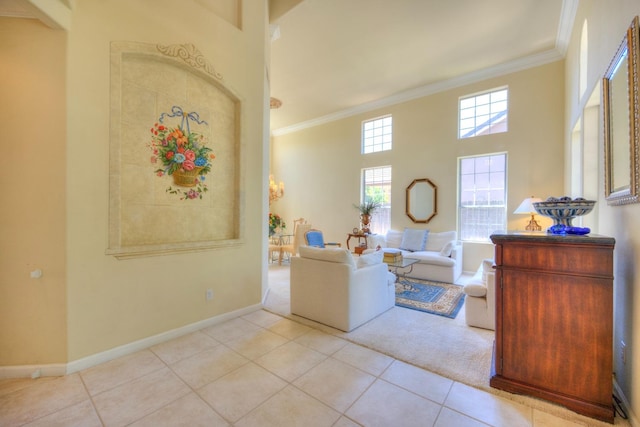 tiled living area featuring ornamental molding, baseboards, and a high ceiling