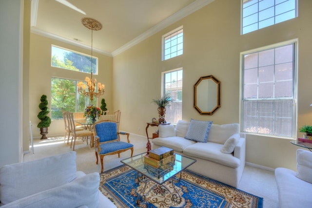 carpeted living room with a towering ceiling, baseboards, ornamental molding, and a notable chandelier