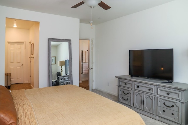 carpeted bedroom featuring baseboards and a ceiling fan