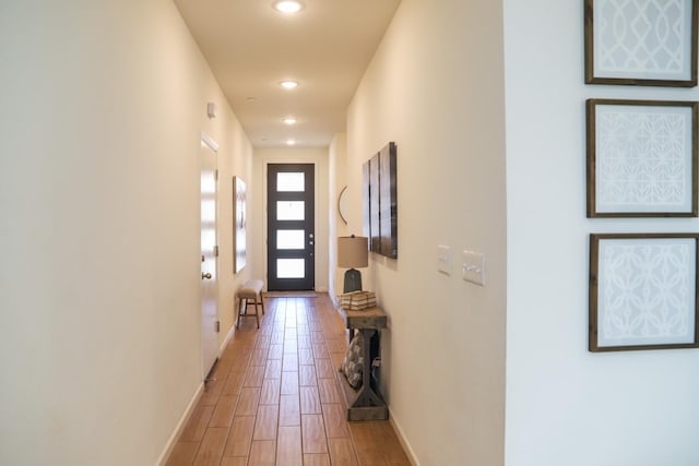 doorway to outside featuring recessed lighting, baseboards, and light wood finished floors