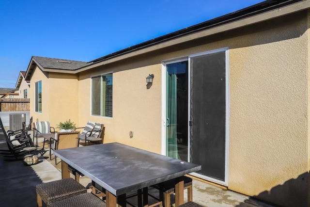 view of patio featuring outdoor dining space and fence