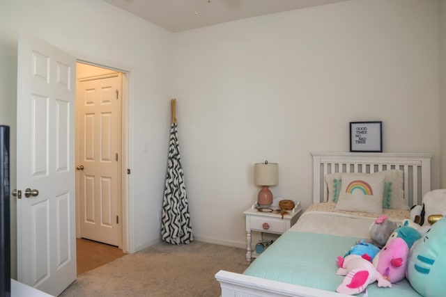 bedroom with carpet floors and baseboards