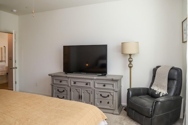 bedroom featuring light carpet and baseboards