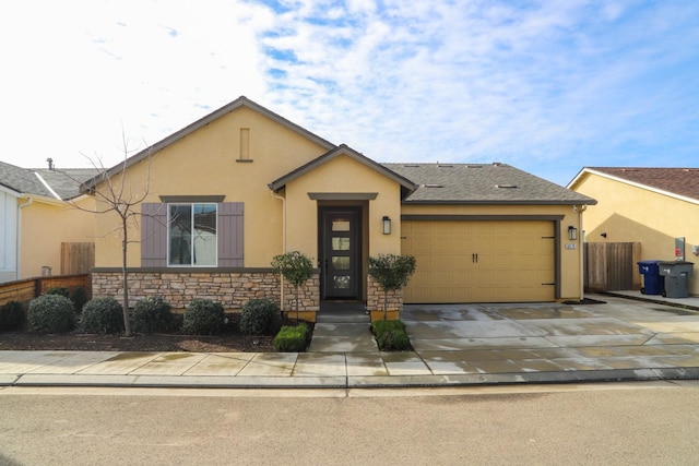 ranch-style house featuring concrete driveway, stone siding, an attached garage, fence, and stucco siding