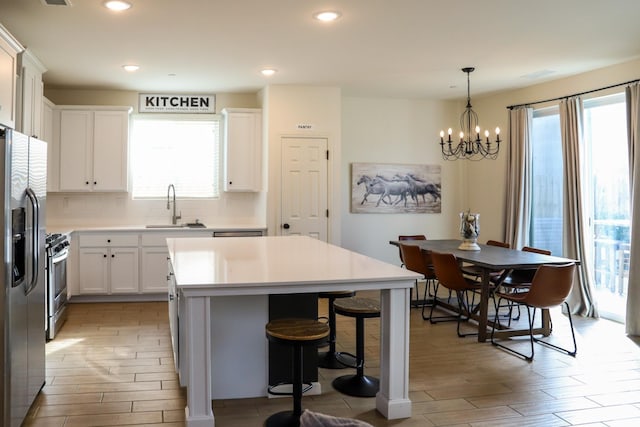 kitchen featuring appliances with stainless steel finishes, plenty of natural light, a sink, and tasteful backsplash