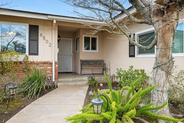 doorway to property with stucco siding