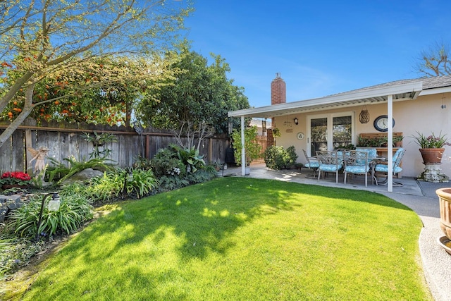 view of yard featuring fence and a patio