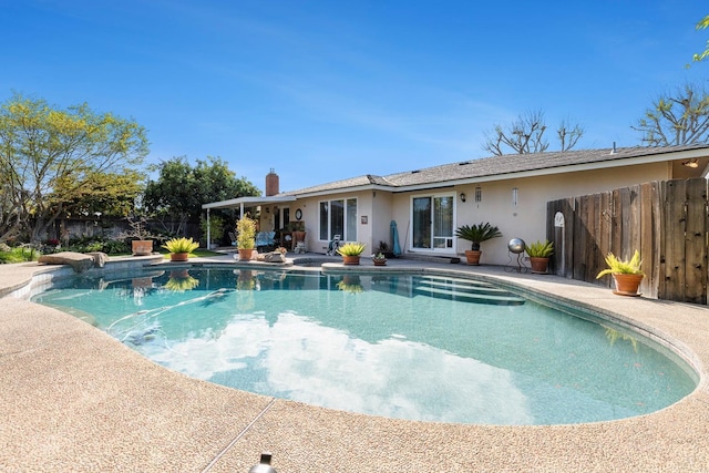 view of swimming pool featuring fence, a fenced in pool, and a patio