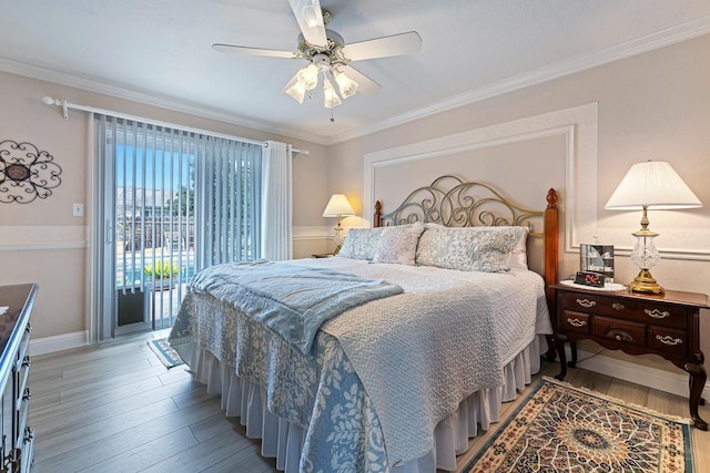 bedroom featuring ornamental molding, wood finished floors, and access to exterior