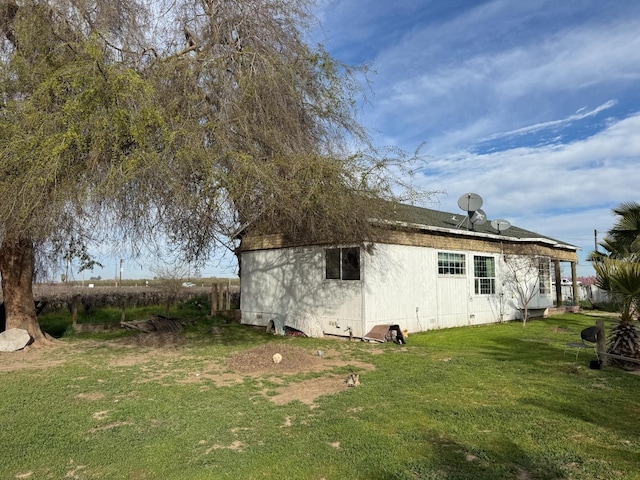 exterior space with crawl space and a lawn