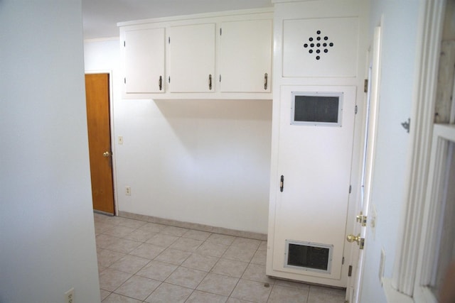 laundry area featuring light tile patterned floors, visible vents, and crown molding