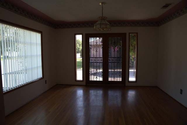 interior space with wood finished floors and visible vents