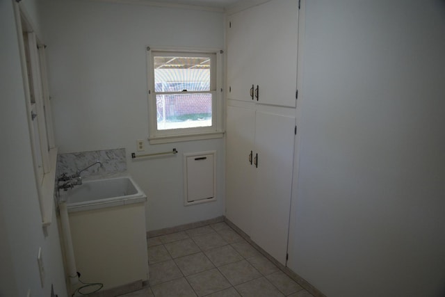 washroom with light tile patterned floors and a sink