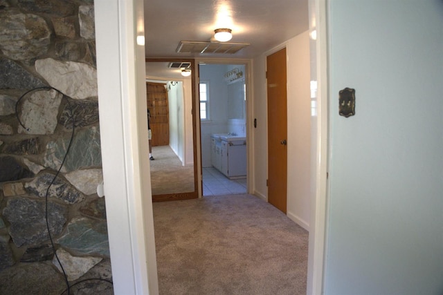 hall with carpet and visible vents