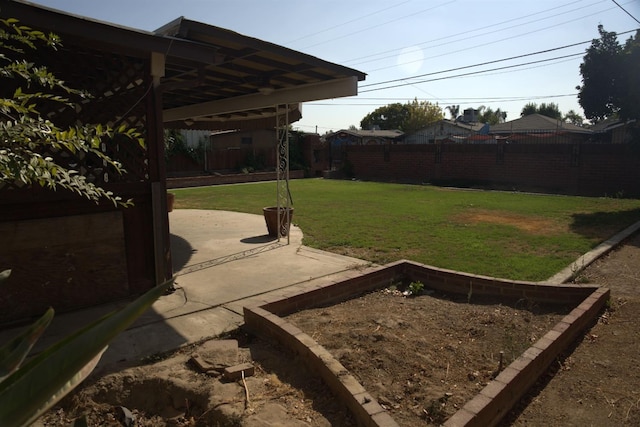 view of yard with fence and a patio