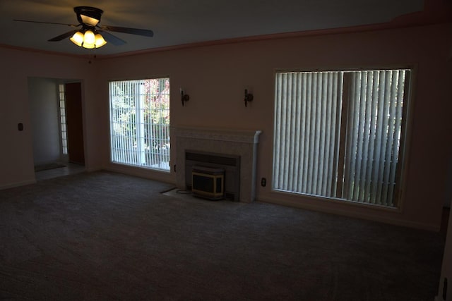 unfurnished living room with carpet flooring, crown molding, and ceiling fan