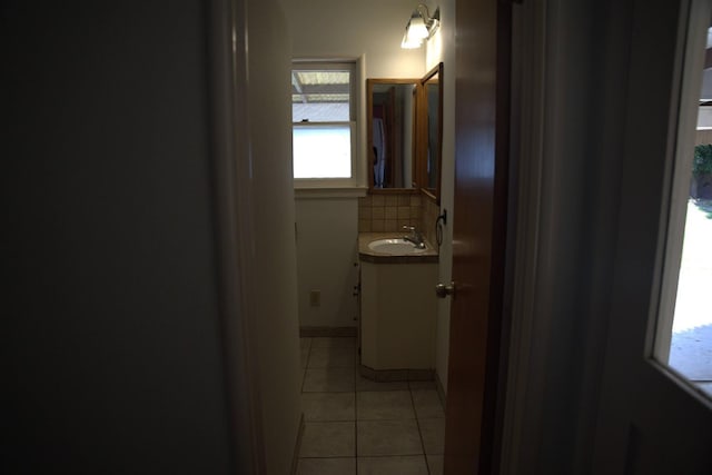 bathroom featuring backsplash, tile patterned flooring, and vanity