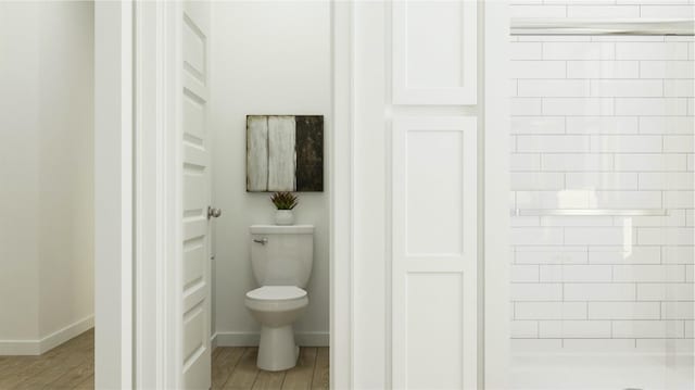 full bath with baseboards, toilet, wood finished floors, and a shower stall