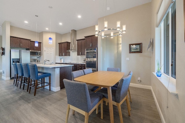 dining area featuring recessed lighting, wood finished floors, and baseboards