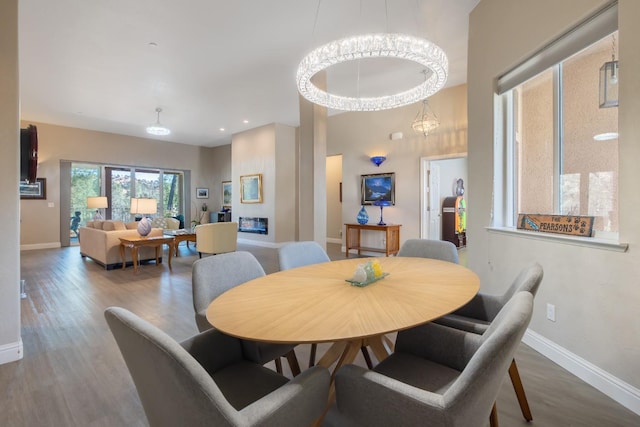 dining space featuring baseboards and wood finished floors