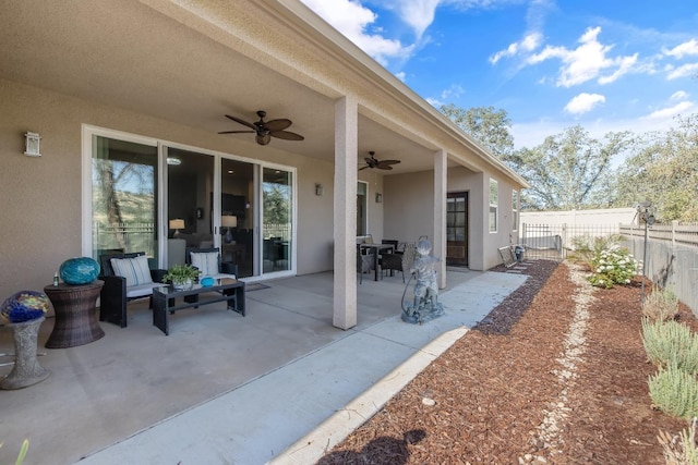 view of patio / terrace with fence and a ceiling fan