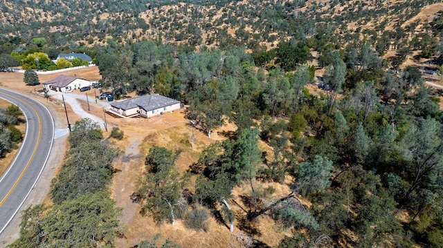 drone / aerial view featuring a view of trees