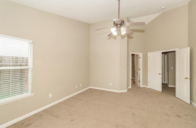 unfurnished bedroom with light colored carpet, multiple windows, ceiling fan, and baseboards