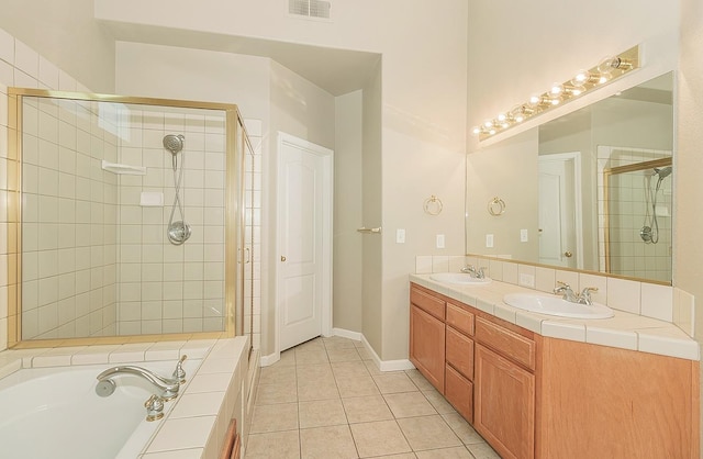 full bathroom with a stall shower, tile patterned flooring, visible vents, and a sink