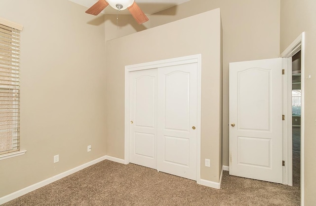 unfurnished bedroom with a closet, baseboards, and carpet flooring