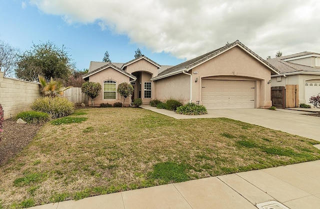 ranch-style home featuring a garage, fence, concrete driveway, and stucco siding