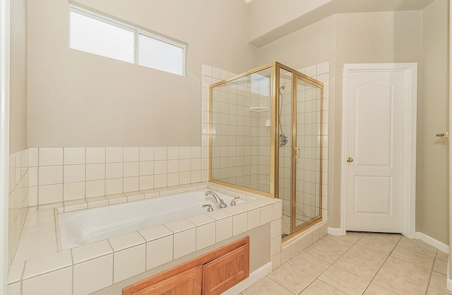 full bath with a garden tub, a stall shower, tile patterned flooring, and baseboards