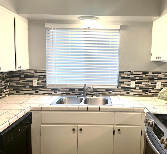 kitchen featuring tasteful backsplash, black dishwasher, stainless steel range with electric cooktop, and a sink