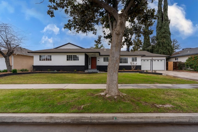 ranch-style home with a garage, driveway, a front lawn, and stucco siding