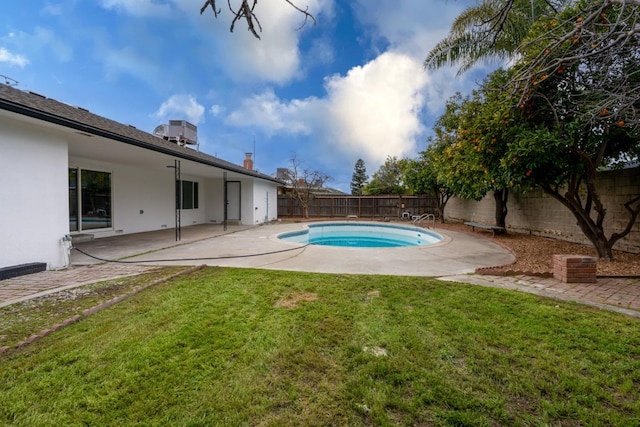 view of swimming pool with a fenced in pool, a lawn, a patio area, central AC, and a fenced backyard