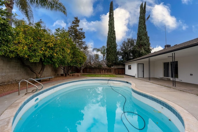 view of swimming pool featuring a fenced in pool, a patio area, and a fenced backyard