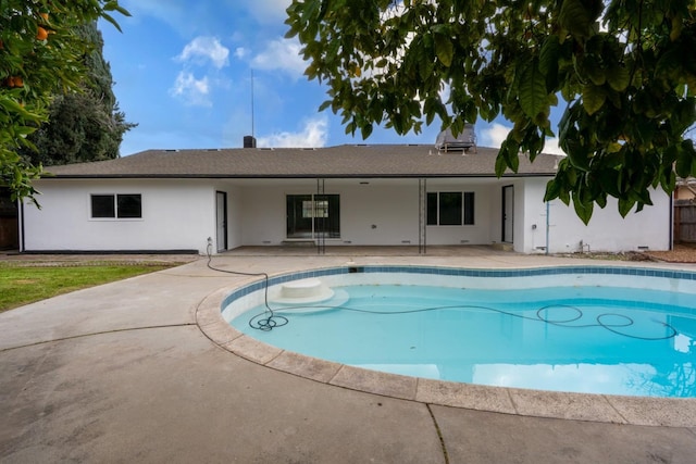 pool featuring a patio area and fence