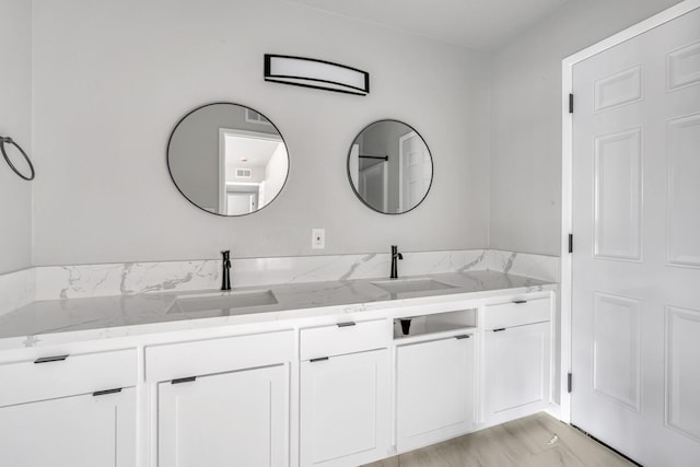 bathroom with double vanity and a sink