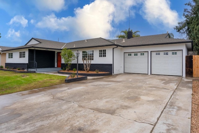 single story home with driveway, stucco siding, an attached garage, fence, and a front yard