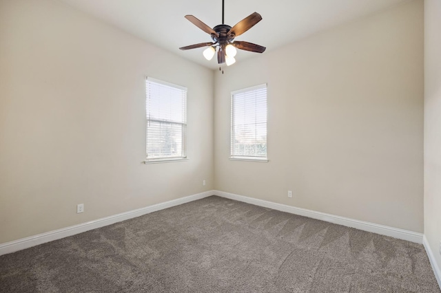 spare room featuring baseboards, a ceiling fan, and carpet floors