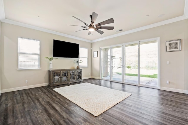 unfurnished living room with dark wood-type flooring, visible vents, crown molding, and baseboards