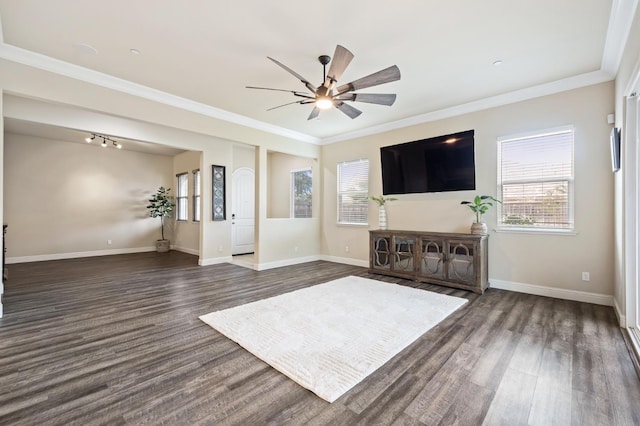 unfurnished living room with baseboards, dark wood finished floors, and crown molding