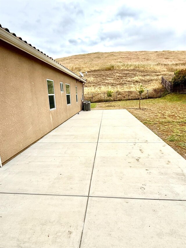 view of patio / terrace featuring fence