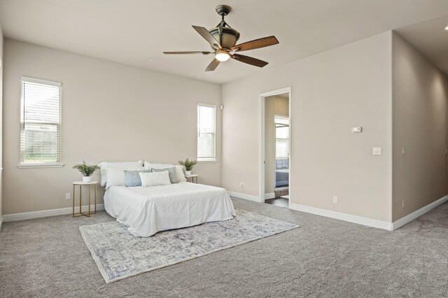 carpeted bedroom featuring baseboards, a ceiling fan, and multiple windows