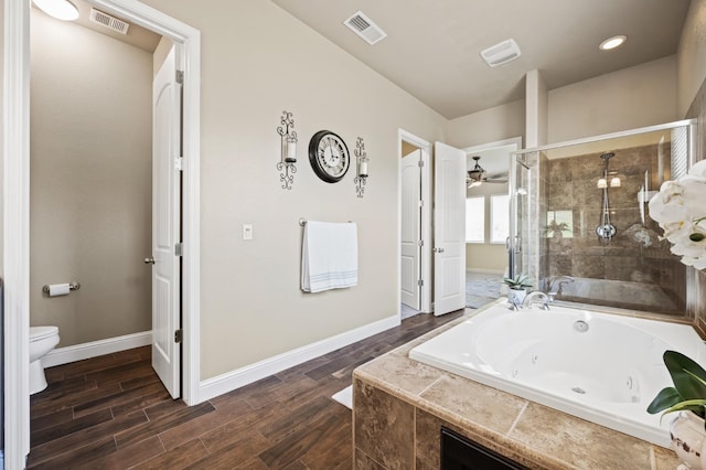 bathroom with toilet, a shower stall, visible vents, and a jetted tub