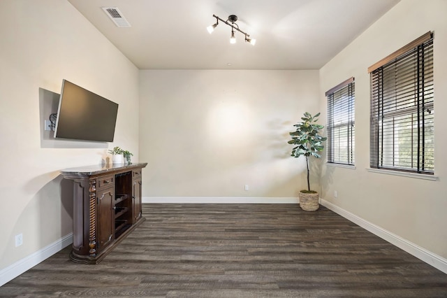 interior space featuring baseboards, visible vents, and wood finished floors