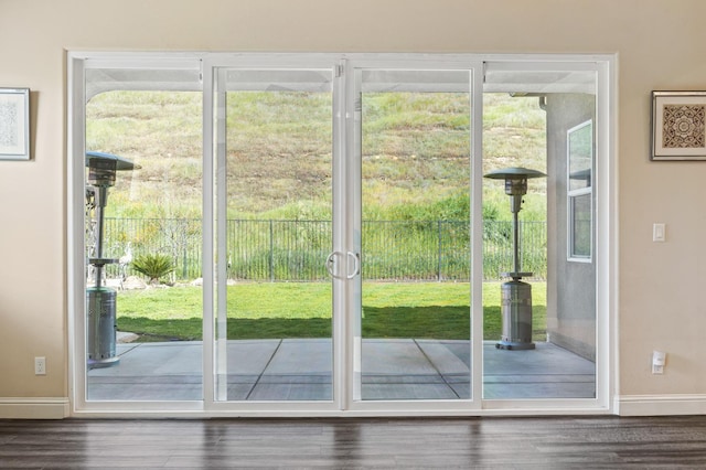 entryway featuring dark wood-style floors and baseboards