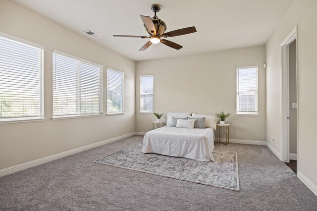 bedroom with a ceiling fan, baseboards, visible vents, and carpet flooring